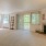 Large open living room with windows and a fireplace