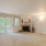 Large open living room with windows and a fireplace
